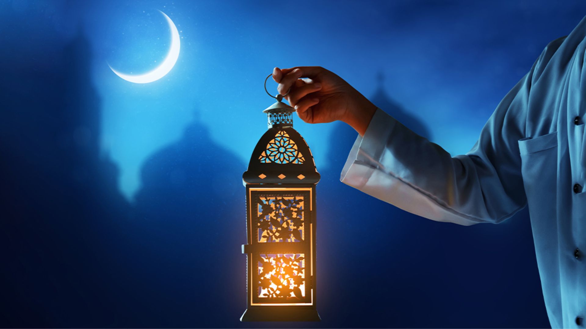 Night lamp in hand against the moon