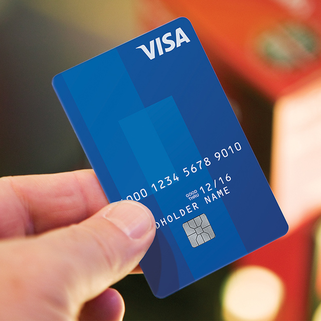 Marquee-VE-VisaCard-640x640 Close up of blue Visa Card being held up by a person.
