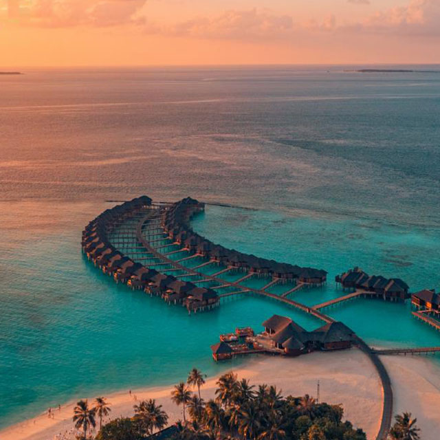 Beach by the ocean at sunset, view from above