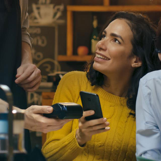 Person paying via a POS terminal using a phone