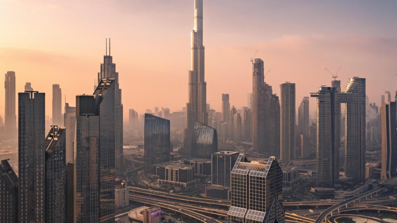 Dubai skyline at sunset with Burj Khalifa towering above modern skyscrapers