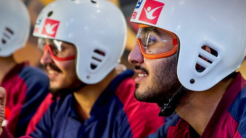 Men wearing helmets and goggles during an indoor adventure activity